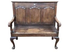 Period style triple arched fielded panel back settle, 107cm by 110cm by 52cm.