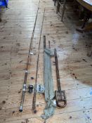 Vintage bamboo shooting stick and four vintage fishing rods.