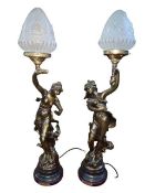 Two ornate bronzed effect lady table lamps.