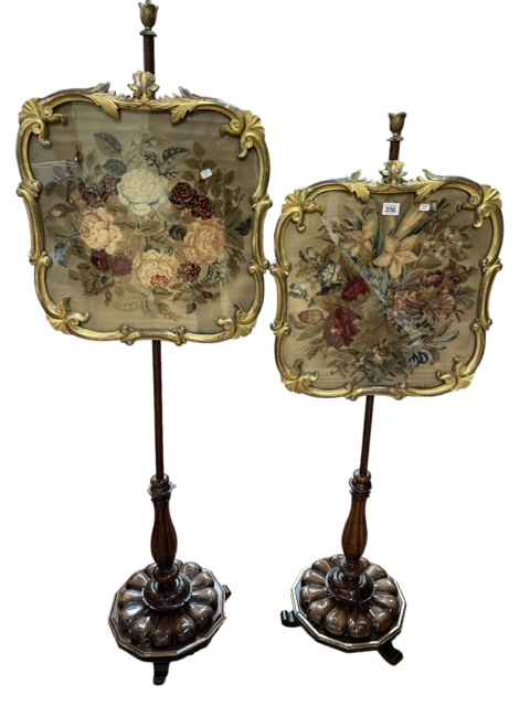 Pair Victorian rosewood and giltwood glazed needlework panel pole screens on triform base.