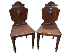 Pair Victorian mahogany hall chairs on turned legs.