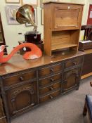 Carved oak sideboard, small oak bureau and oak and buttoned hide armchair (3).