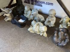 Collection of nine garden ornaments including Buddha's, dogs, boot planter, etc.