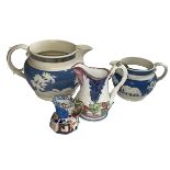 Two blue and white Jasperware relief moulded jugs, Victorian jug with mask spout and Davenport jug.