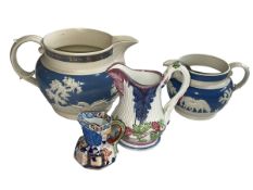 Two blue and white Jasperware relief moulded jugs, Victorian jug with mask spout and Davenport jug.