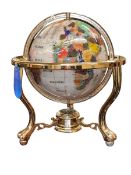 Semi-precious stone and brass bound globe with a compass base, 35cm high.