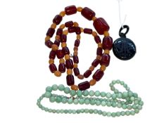 Amber and jade beads, and jet locket (3).