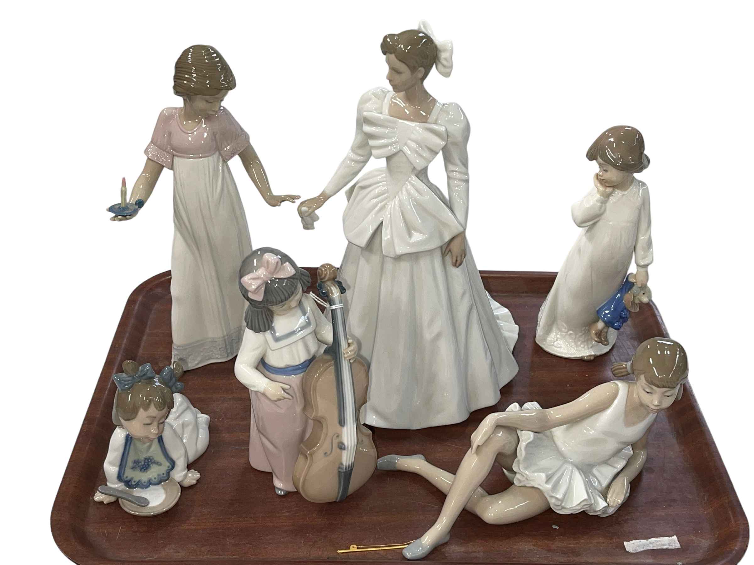Six Nao figurines.
