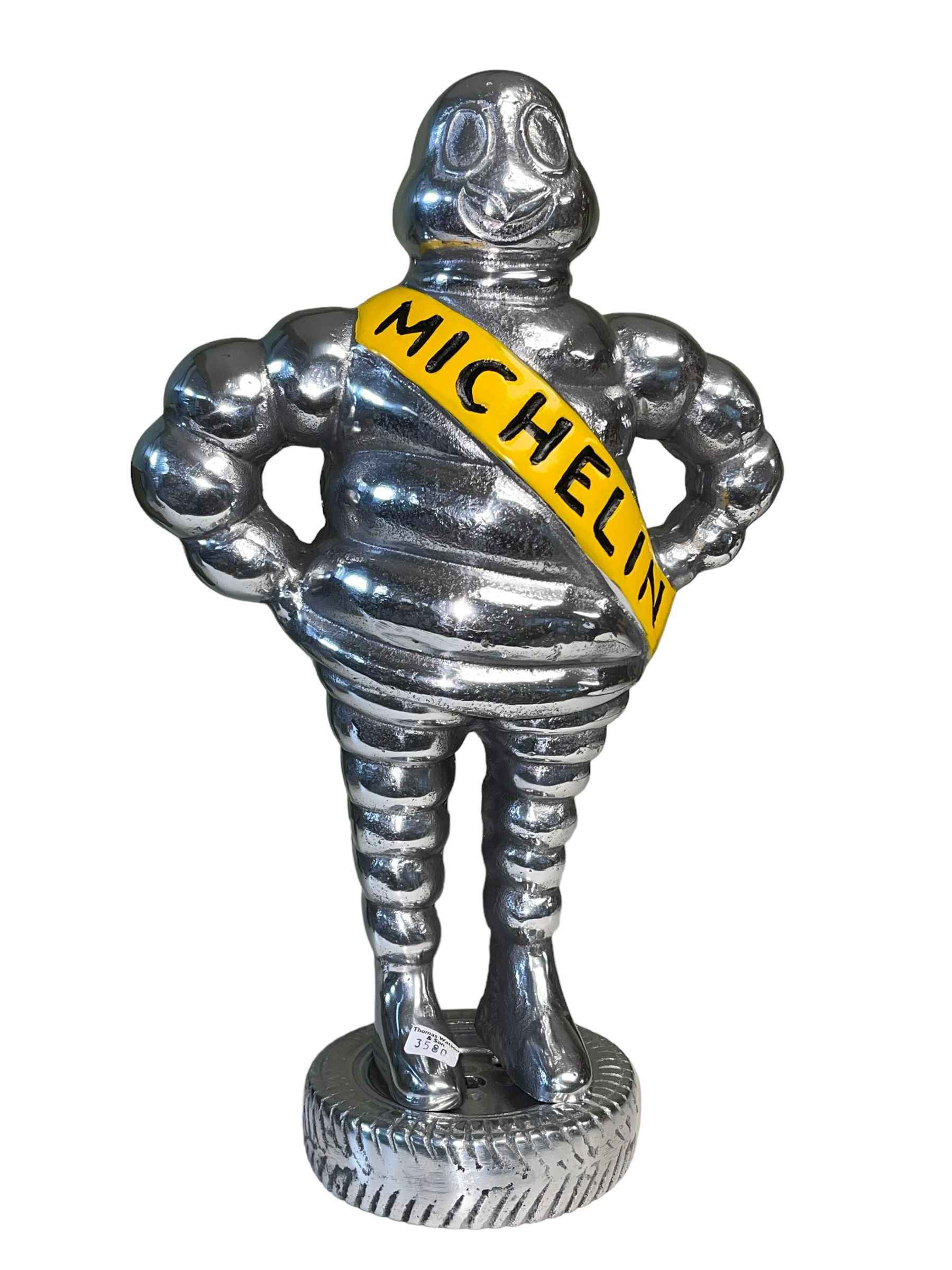 Silver coloured Michelin Man, 38cm high.