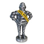 Silver coloured Michelin Man, 38cm high.