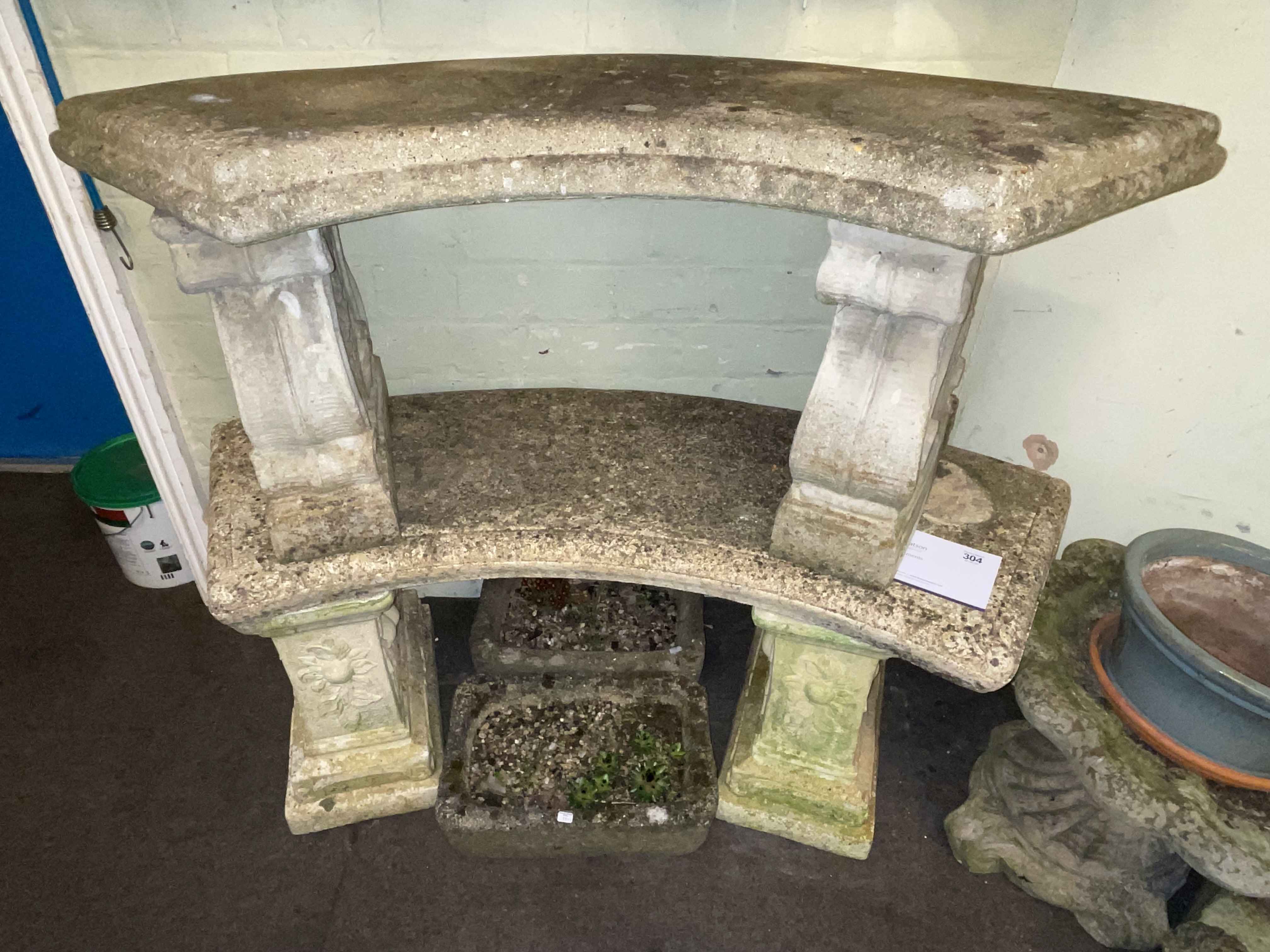 Two composite stone concave garden benches.