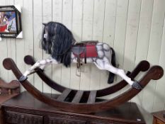 Sponge painted rocking horse with leather saddle, 102cm by 176cm.
