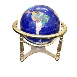 Semi-precious stone and brass bound globe with a compass base, 41cm high.