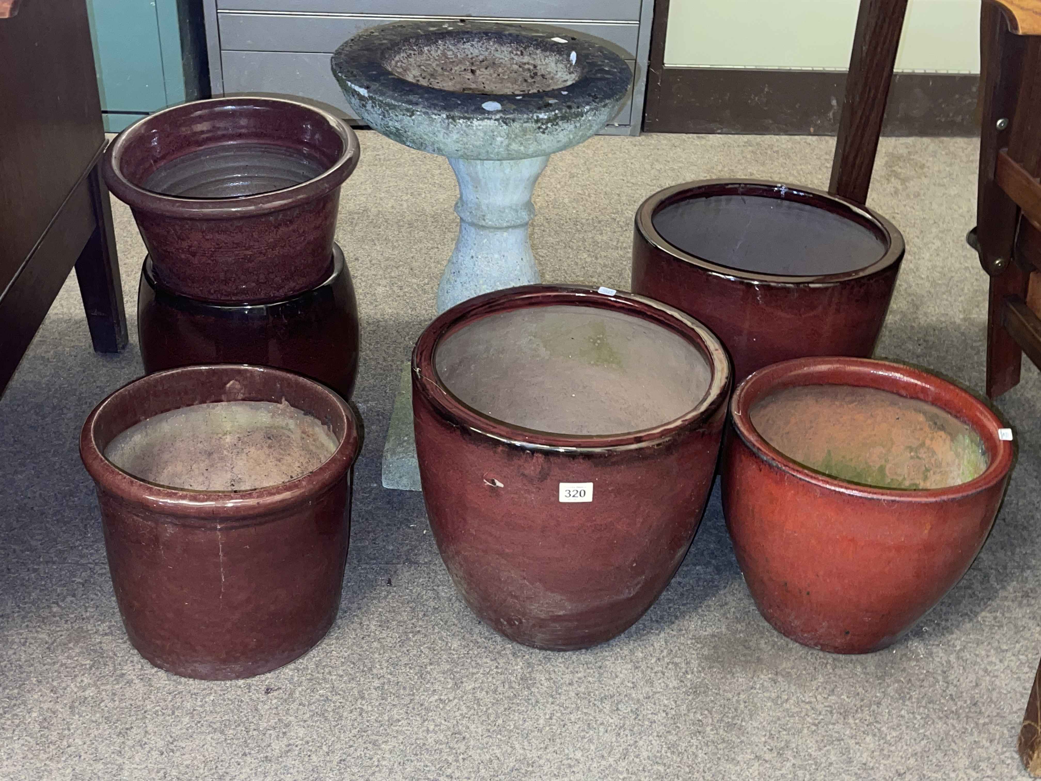 Pedestal bird bath and six various glazed pottery planters.
