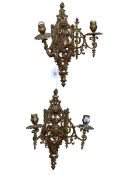 Pair of ornate brass two branch wall sconces.