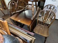 Oak drop leaf dining table, four Ercol dining chairs and Ercol armchair (6).