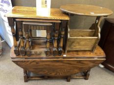 Oval oak drop leaf coffee table, nest of three oak tables and oak magazine table (3).