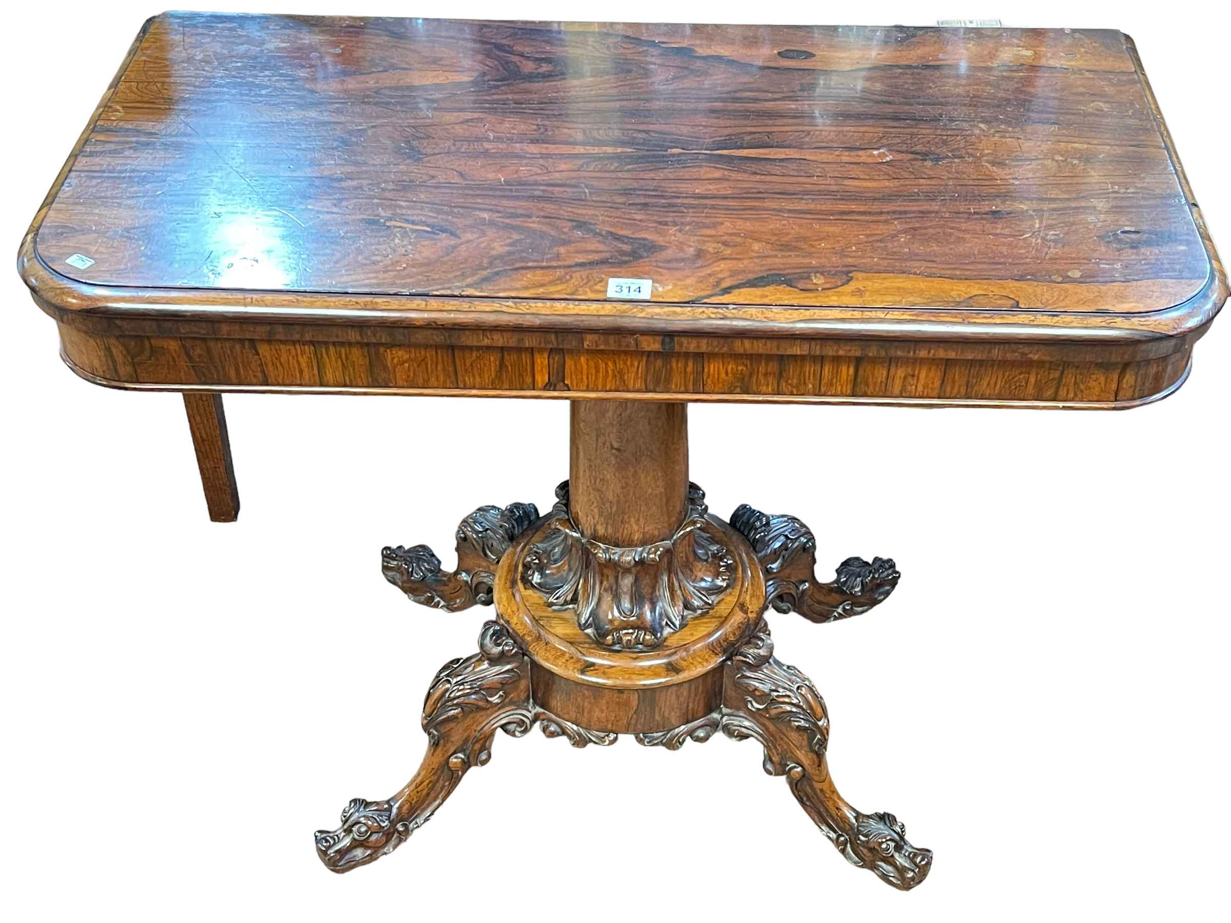 Victorian rosewood fold top tea table on turned pedestal to four carved scrolled legs, 73.