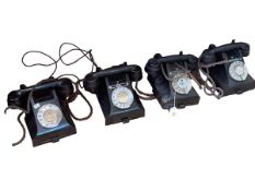 Four vintage dial telephones.