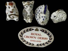 Four Royal Crown Derby paperweights and sign, 25th Anniversary Rabbits with certificates,