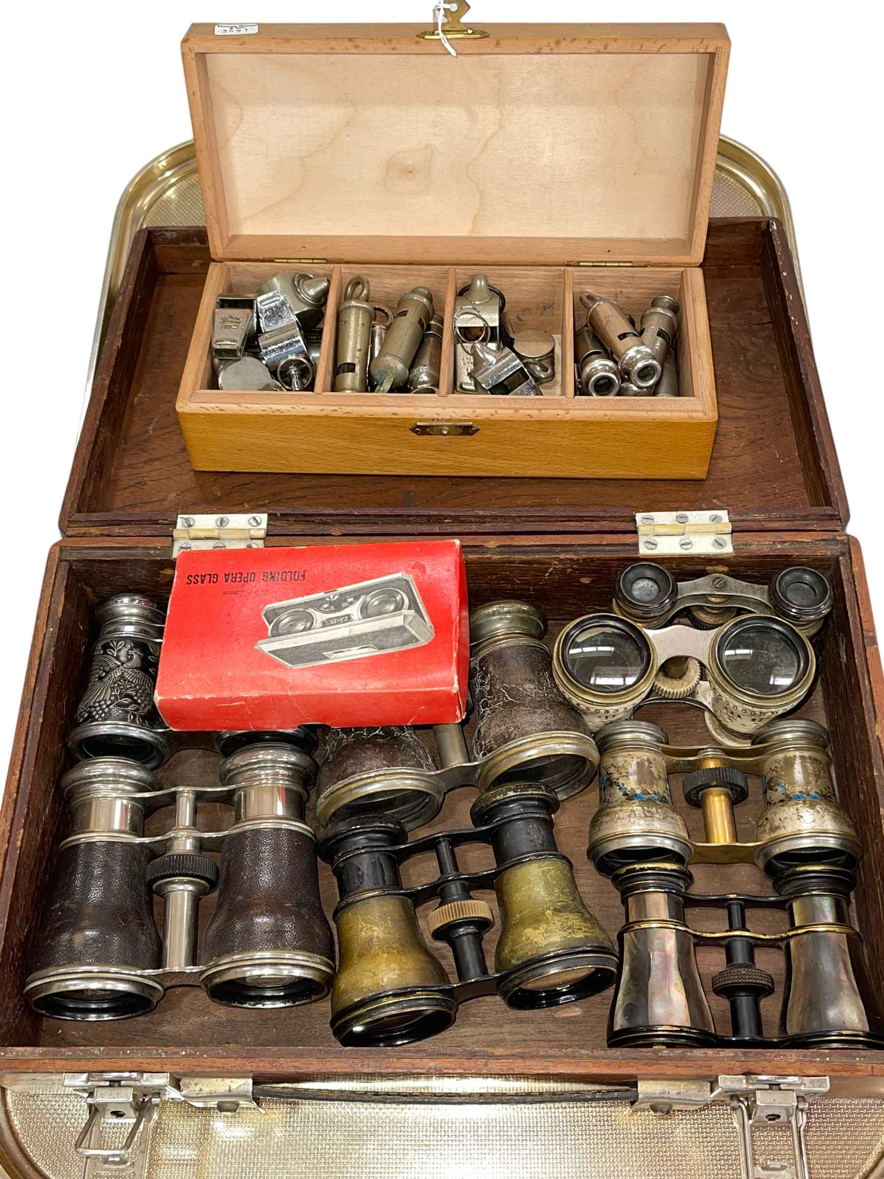 Collection of opera glasses and whistles.