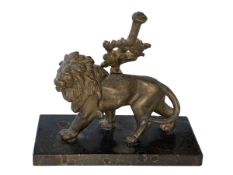 Ornate metal sculpture of a lion on a marble base.