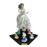 Large Lladro Quinceanera figure and seven Royal Doulton miniature figures and stand.