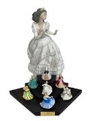 Large Lladro Quinceanera figure and seven Royal Doulton miniature figures and stand.