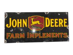 Tin sign marked 'John Deere Farm Implements', 45cm by 21cm.