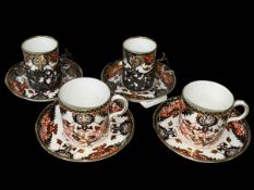 Four Royal Crown Derby Imari coffee cups and saucers, two with silver holders.