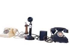 Vintage stick telephone and two vintage dial telephones.