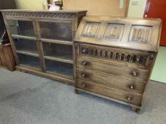 Oak double glazed door bookcase and linen fold panel four drawer bureau (2).