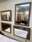 Collection of four gilt framed wall mirrors including three bevelled.