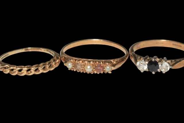 Two 9 carat gold and one 'gold/silver' ring (3).