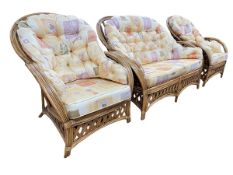 Rattan three piece conservatory suite in abstract print fabric.