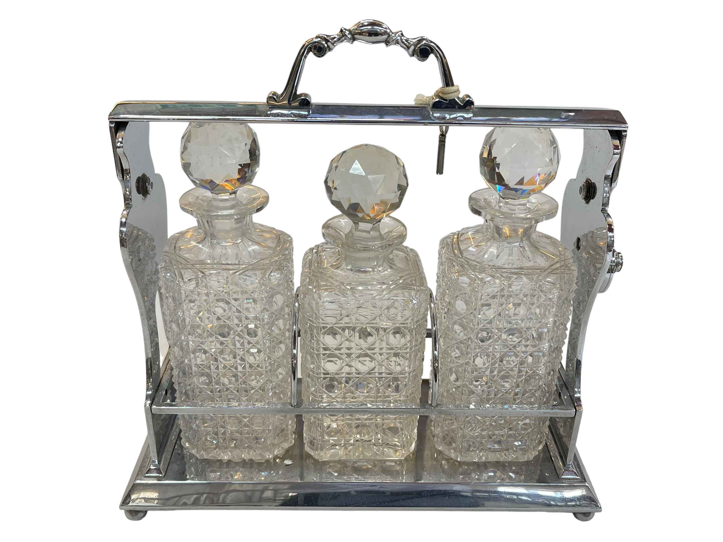 Silver plated three bottled tantalus, 34cm.