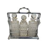 Silver plated three bottled tantalus, 34cm.