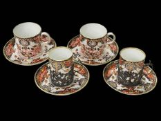 Four Royal Crown Derby Imari coffee cups and saucers, two with silver holders.