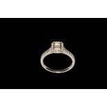 Diamond multi-stone 18 carat white gold engagement ring with three emerald cut centre stones,