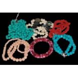 Six gemstone necklaces and bracelets including coral and turquoise.