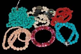 Six gemstone necklaces and bracelets including coral and turquoise.