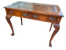 Chippendale style walnut two drawer writing table on ball and claw legs, 78.5cm by 106cm by 59cm.