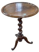 Circular mahogany occasional table on twist pedestal triform base, 74cm by 55cm diameter.