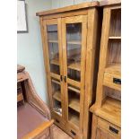 Golden oak cabinet having two bevelled glass panel doors above two drawers, 190cm by 89cm by 40cm.