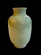Chinese Celadon vase with raised floral pattern, Qianlong mark to base, 23cm.