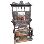Victorian oak mirror back hallstand carved with lion masks and mythical creatures,