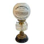 Brass and glass oil lamp with advert shade, Young's Paraffin Oil Co Works West Calder.