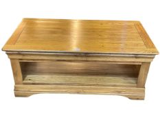 Golden oak rectangular two tier low centre table, 46cm by 110cm by 60cm.