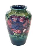 Small Moorcroft vase decorated with anemone on green ground, 10.5cm.