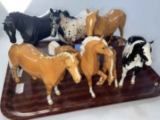 Seven Beswick horses including Appaloosa and Pinto.